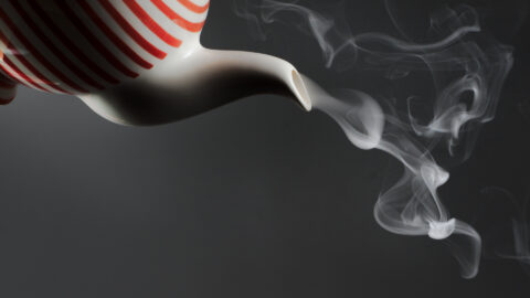 Advertising image of a teapot pouring smoke